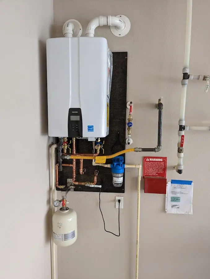 Professional plumber installing copper piping in a Yorkville home